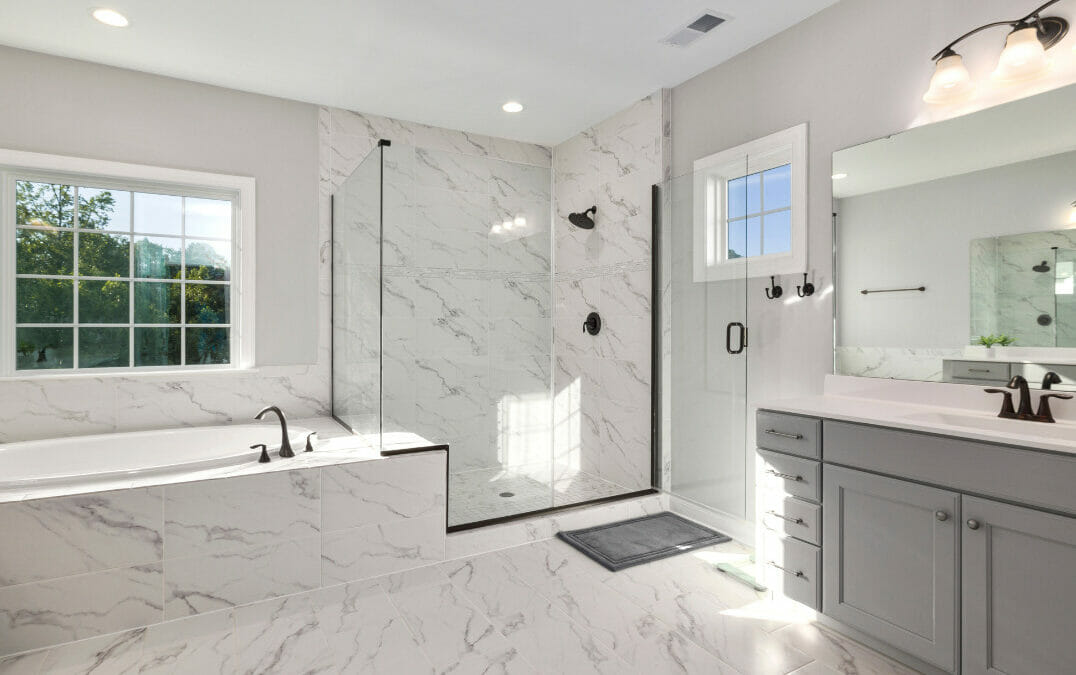 Picture of bathroom with marble floors and glass shower.